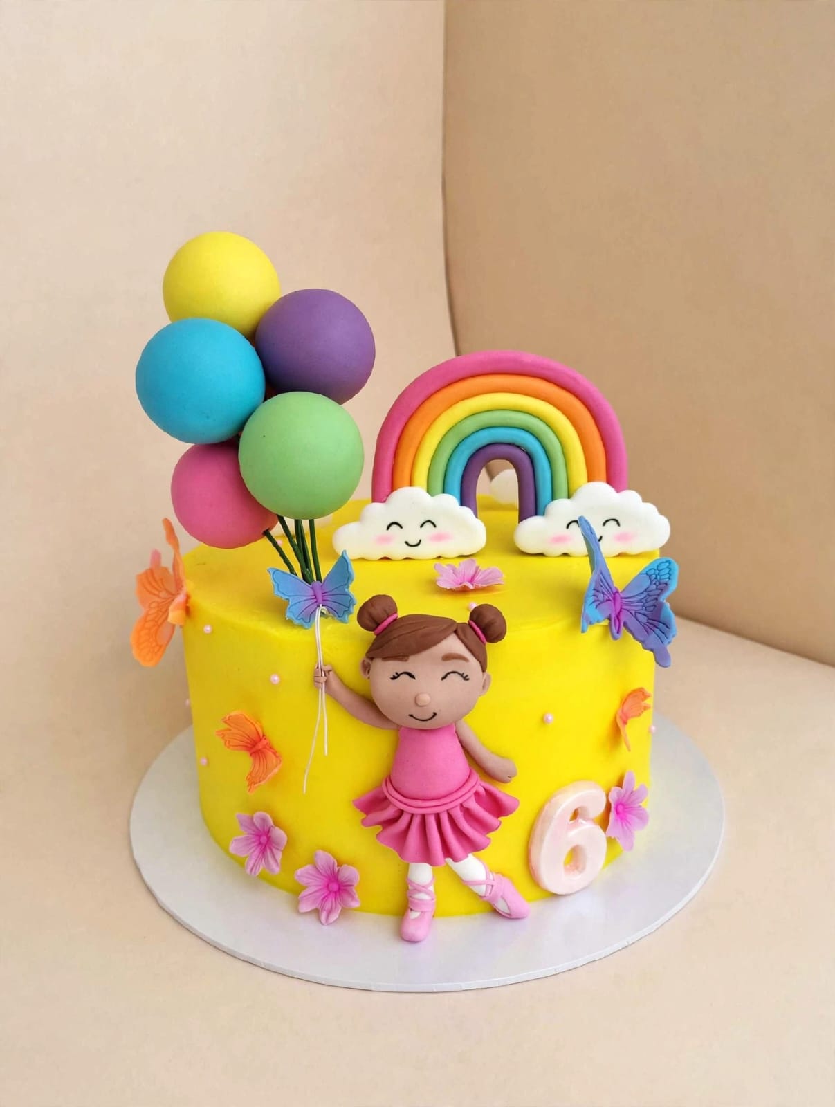 Yellow rainbow balloon birthday cake